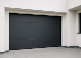 Close-up view of a modern, sleek black garage door installed on a contemporary house.