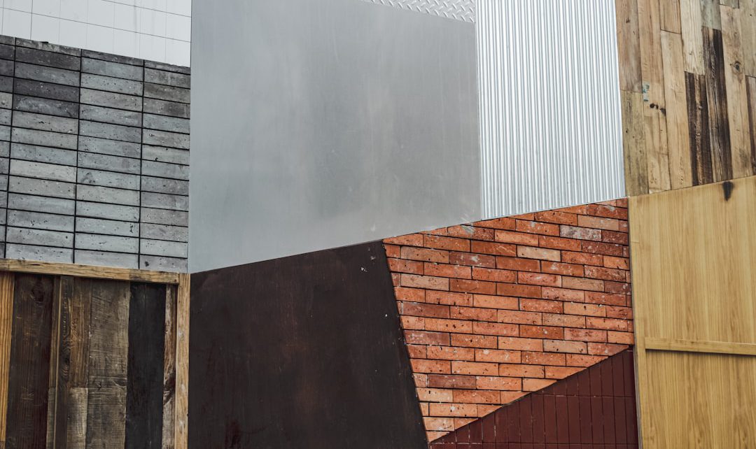 Various textured materials including wood, metal, and brick arranged in an abstract pattern