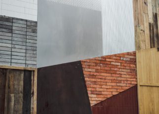Various textured materials including wood, metal, and brick arranged in an abstract pattern